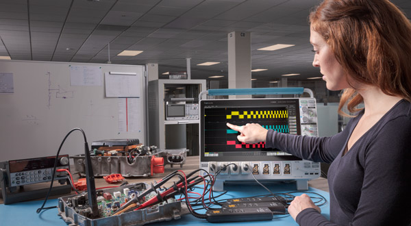 Engineer making measurements on a traction inverter