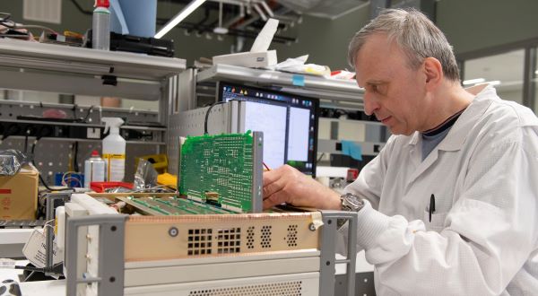 Calibration technician testing a circuit board