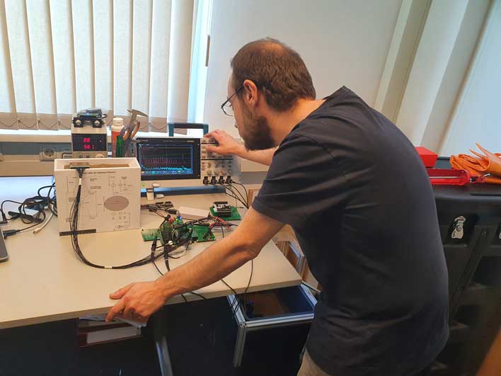 Engineer conducts measurements with Tektronix oscilloscope
